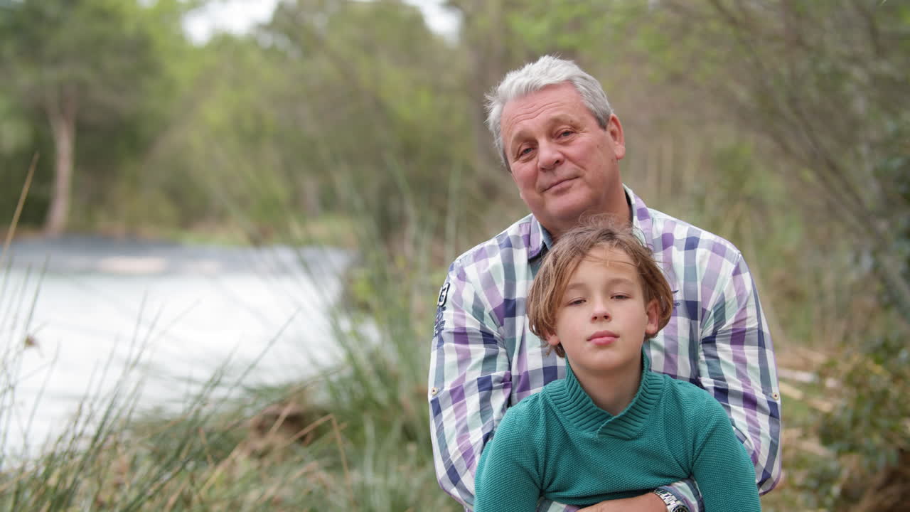 Grandchild with grandfather in quiet countryside