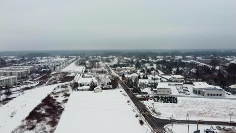 Aerial-drone-video-of-a-town-in-warsaw-covered-in-snow-on-a-cold-winter-day