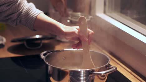 &quot;cooking up penne: slow motion close-up of pasta boiling in a pot