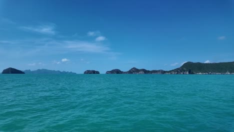 vast view of blue and green ocean water with beautiful rock landmarks in background