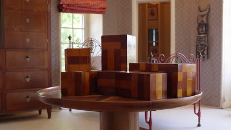 slow rotating shot of multiple different wooden boxes on display at chateau de castille