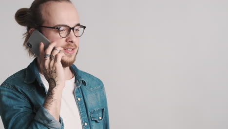 caucasian young man talking on the phone.