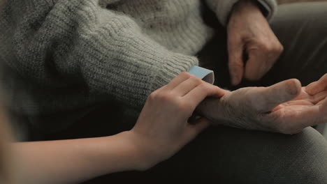 young caring nurse checking hear rate of elderly man