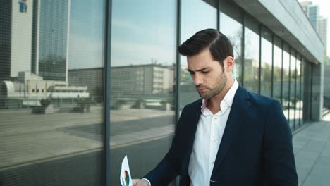 portrait businessman looking through documents. business man throwing papers