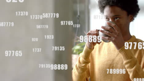 animation of numbers and data processing over african american man with tea in office