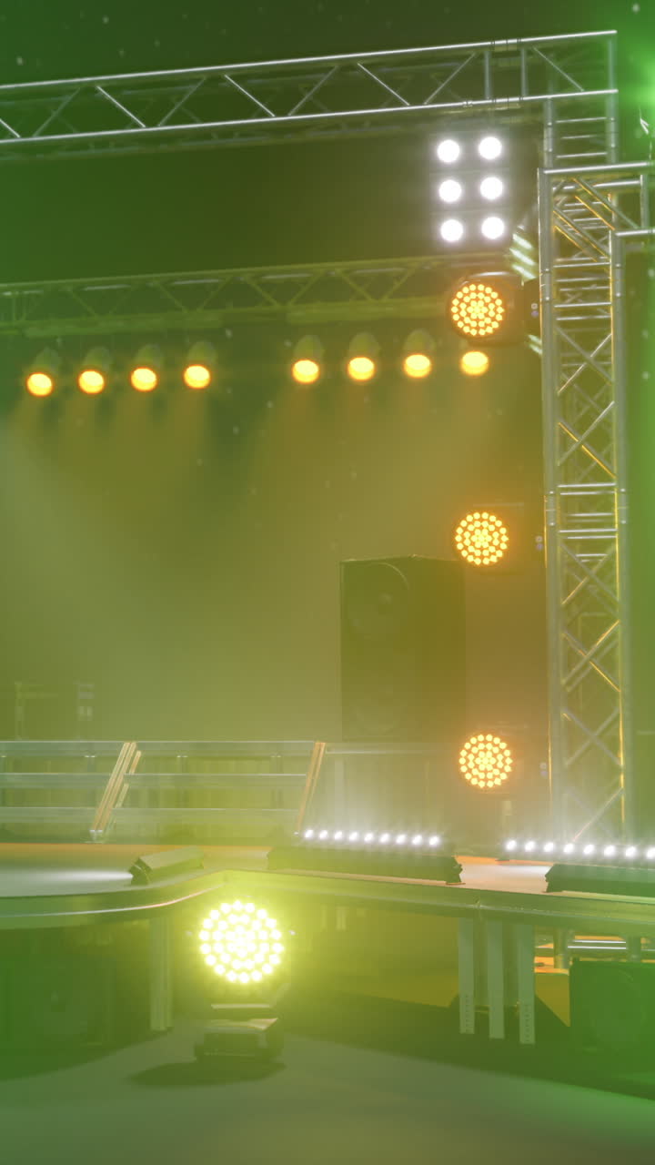 Stage with lights and speakers set for concert or performance in evening