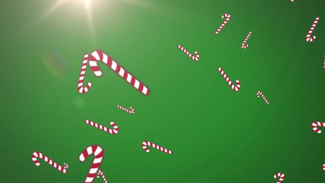 animación de cañas de azúcar de navidad cayendo sobre un fondo verde