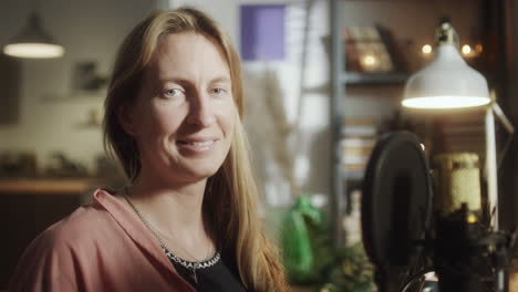 portrait of cheerful woman at home recording studio