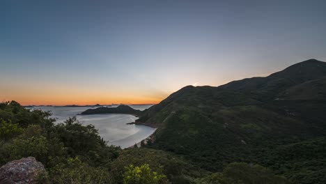 amazing view of sunset on a island. beautiful time lapse video of sundown behind mountains over seacoast. clear sky sunset on lantau island, hong kong.