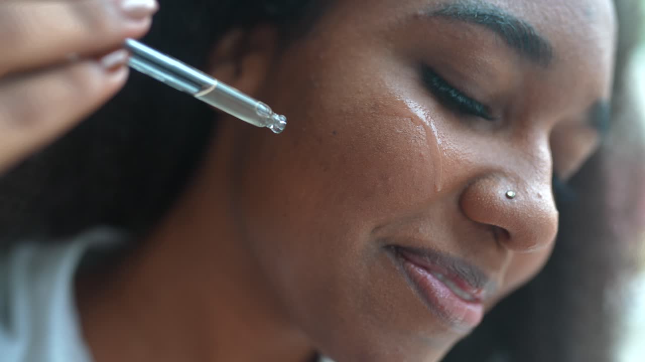 mujer aplicando suero facial