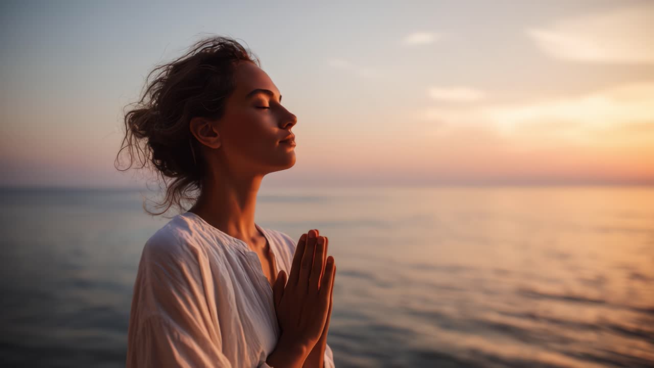 Woman practicing yoga at sunset on beach