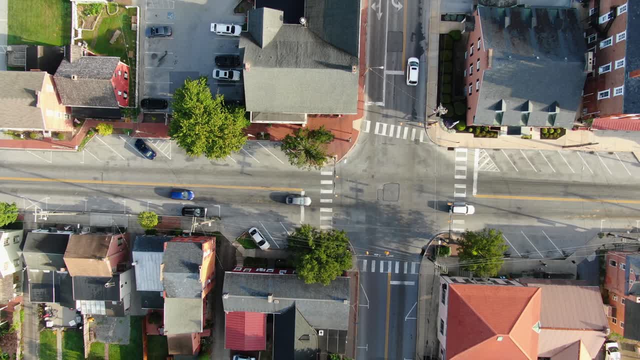 Aerial slow truck shot of traffic passing through intersection at traffic light in USA