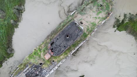 Birdseye-Aerial-View-of-Rusty-Shipwreck-in-Decay