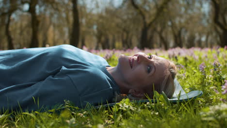 woman lying down on yoga mat