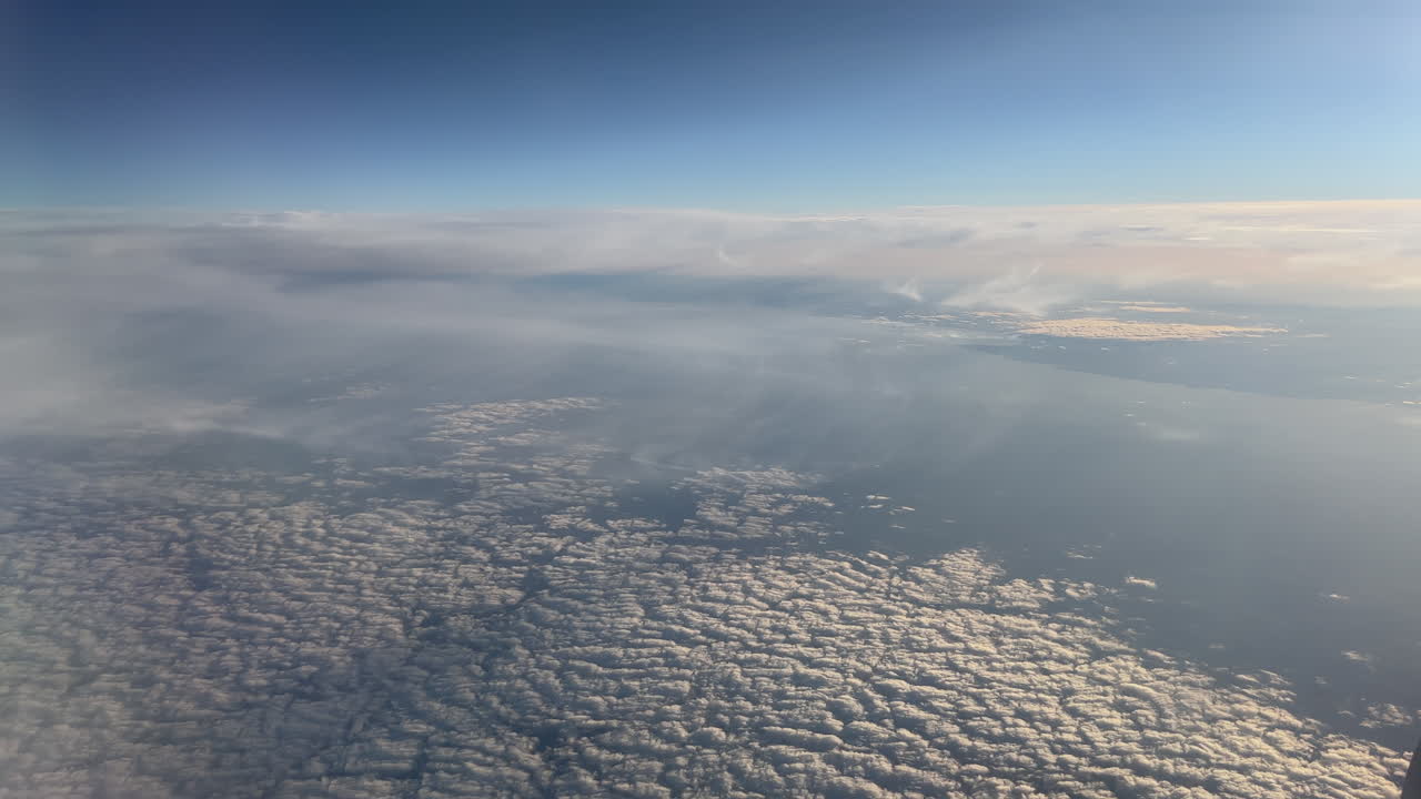 Aerial View of Clouds and Sky from Airplane
