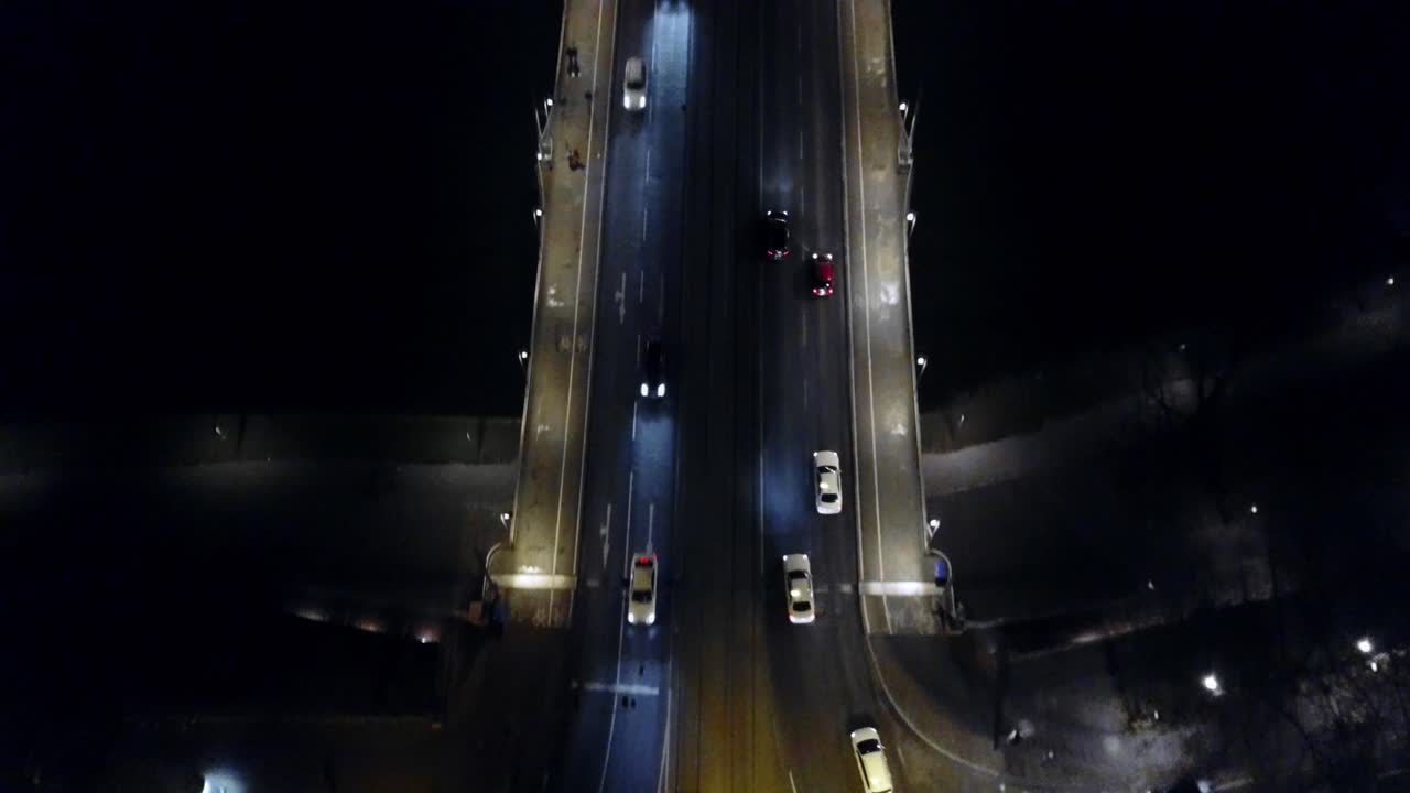 Aerial View of Cars Driving on a Bridge at Night
