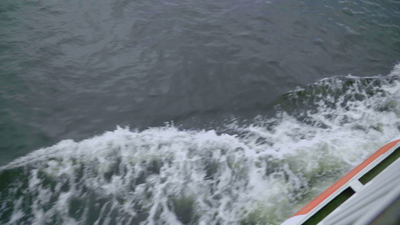 Top down shot of Ferry in japan cutting through sea water in Itsukushima,Miyajima,Japan