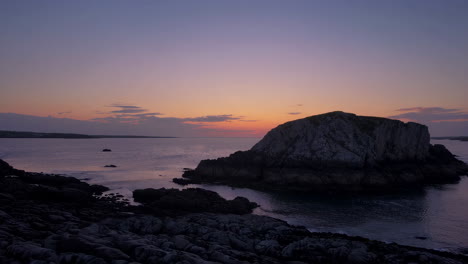 rocky coastal sunset over ocean