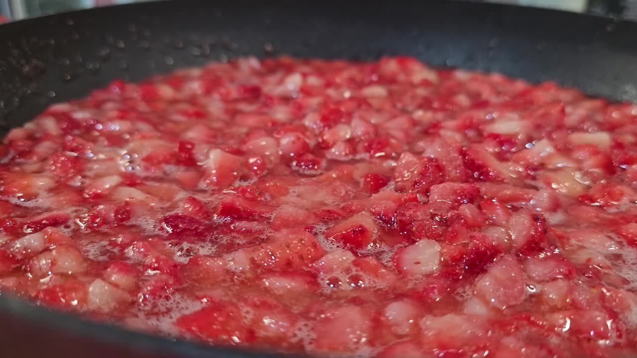 Close Up of Cut Strawberries Cooking in Pan Making Strawberry Jam