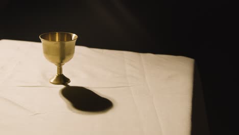 religious concept shot with chalice on altar in pool of light 2