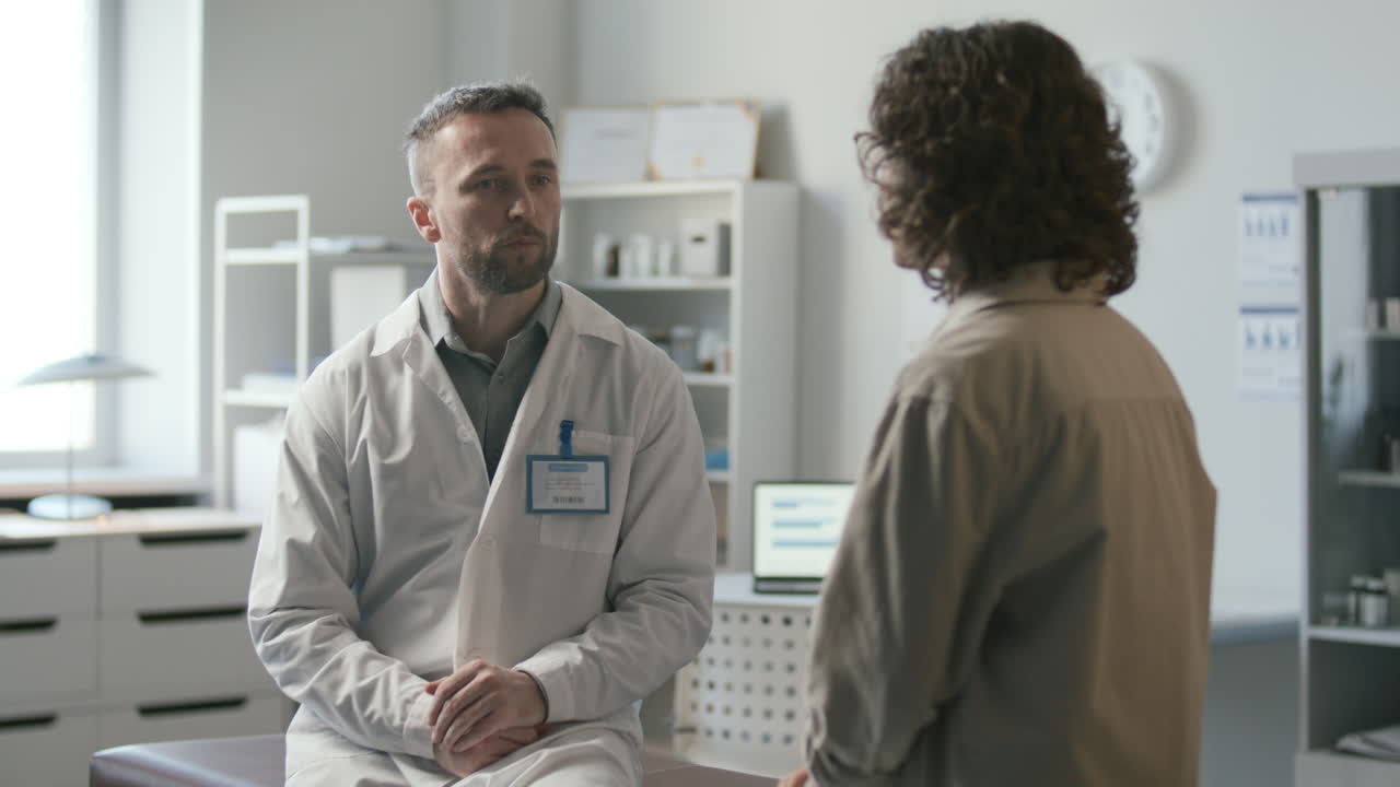 Doctor Explaining Diagnosis to Woman during Medical Consultation