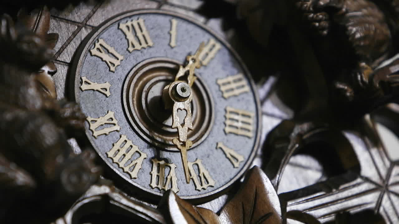 The hands of a cuckoo clock advance in this time lapse shot