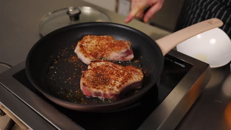 cooking pork chops in a pan