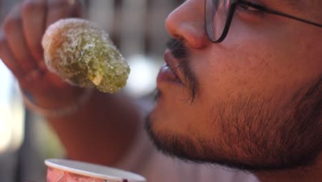 eating kala katta ice gola barf flavour india mumbai maharashtra matheran