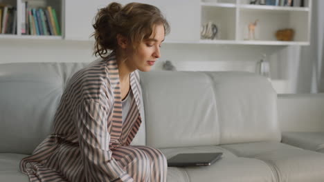 Freelancer-working-home-workplace-closeup.-Girl-drinking-coffee-in-living-room.