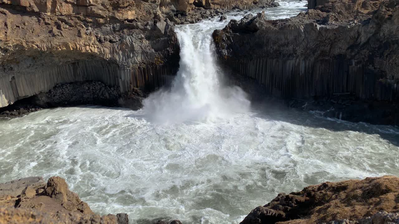 Majestic waterfall Aldeyjarfoss surrounded by basalt rocks in the highlands of Iceland, only available to get to from an F-road