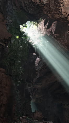 sunlight beams through a dark cave