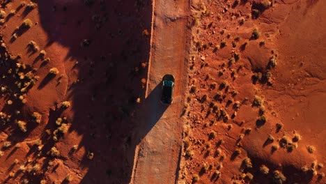 Modern-car-driving-at-Monument-Valley-desert-by-sunset