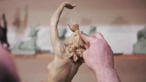 sculpting a female figure in clay