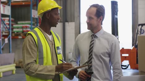 male warehouse manager and warehouse worker in loading bay 4k