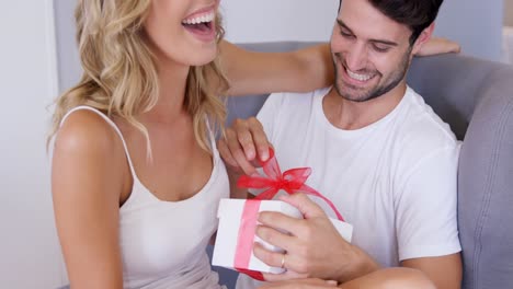 man opening a gift he just received