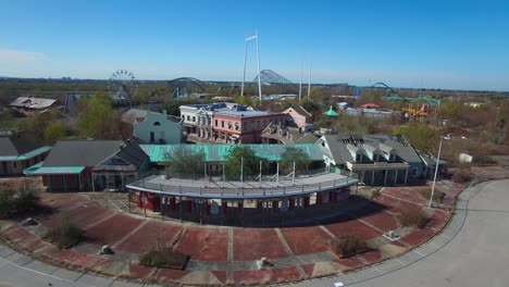 rising aerial shot over an abandoned and decaying theme park