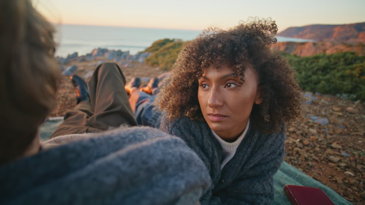 Carefree couple lying beach evening time closeup. Lovely pair relaxing cliff