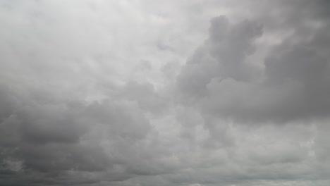 Grey-storm-clouds-racing-away-from-camera,-60x-time-lapse