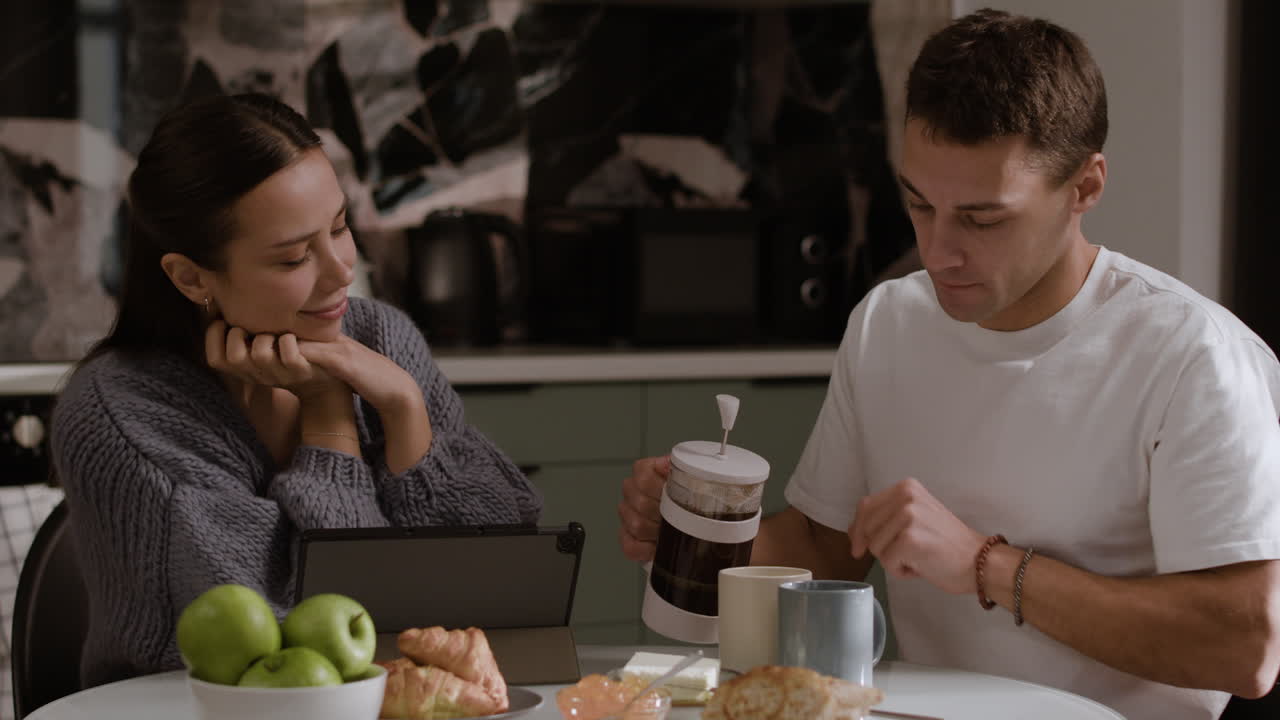 Couple Kissing and Having Breakfast
