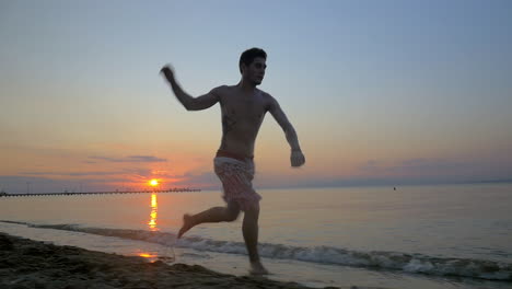 acrobat making somersault on the beach