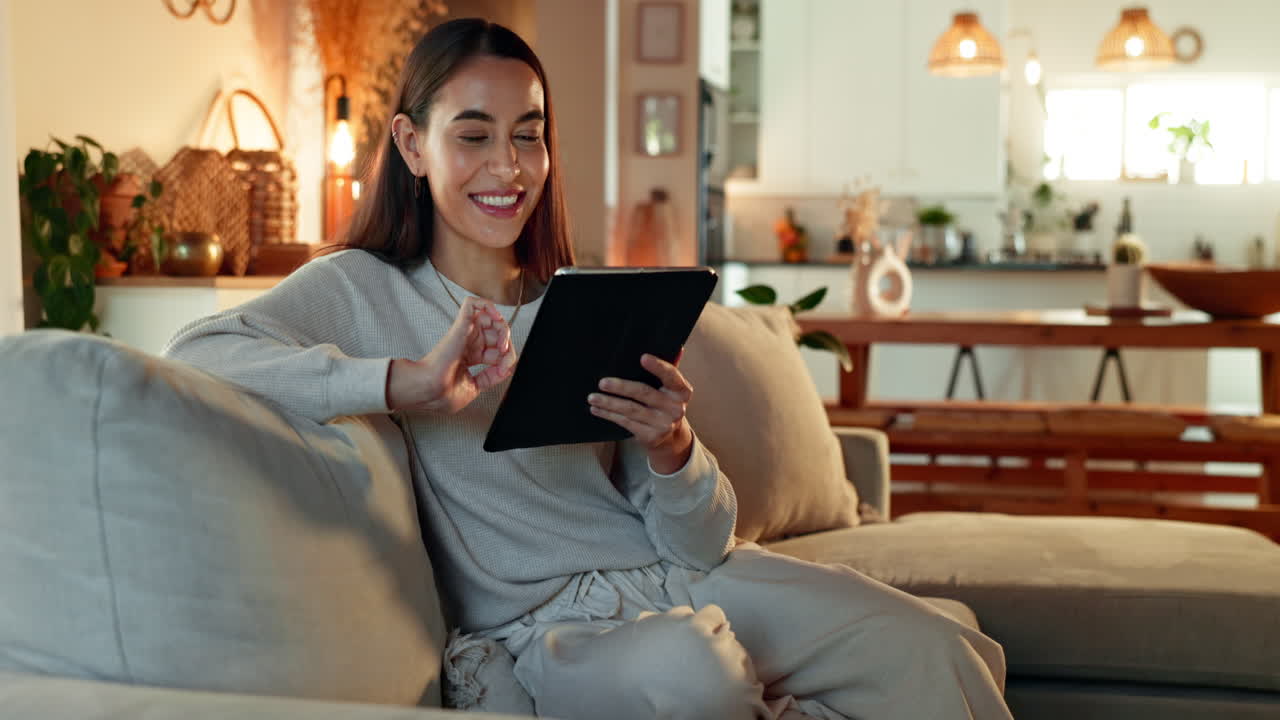 Woman Relaxing on Couch Using Tablet