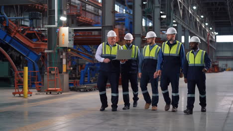 industrial team walking and discussing in a factory