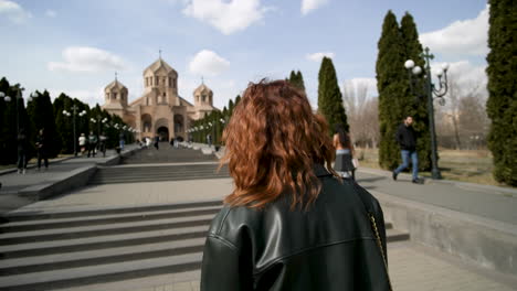 woman visiting a church in a city park