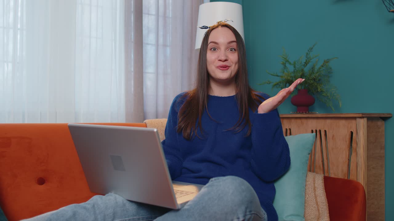 Young adult woman at home office use laptop pc typing browsing say wow yes found out great big win