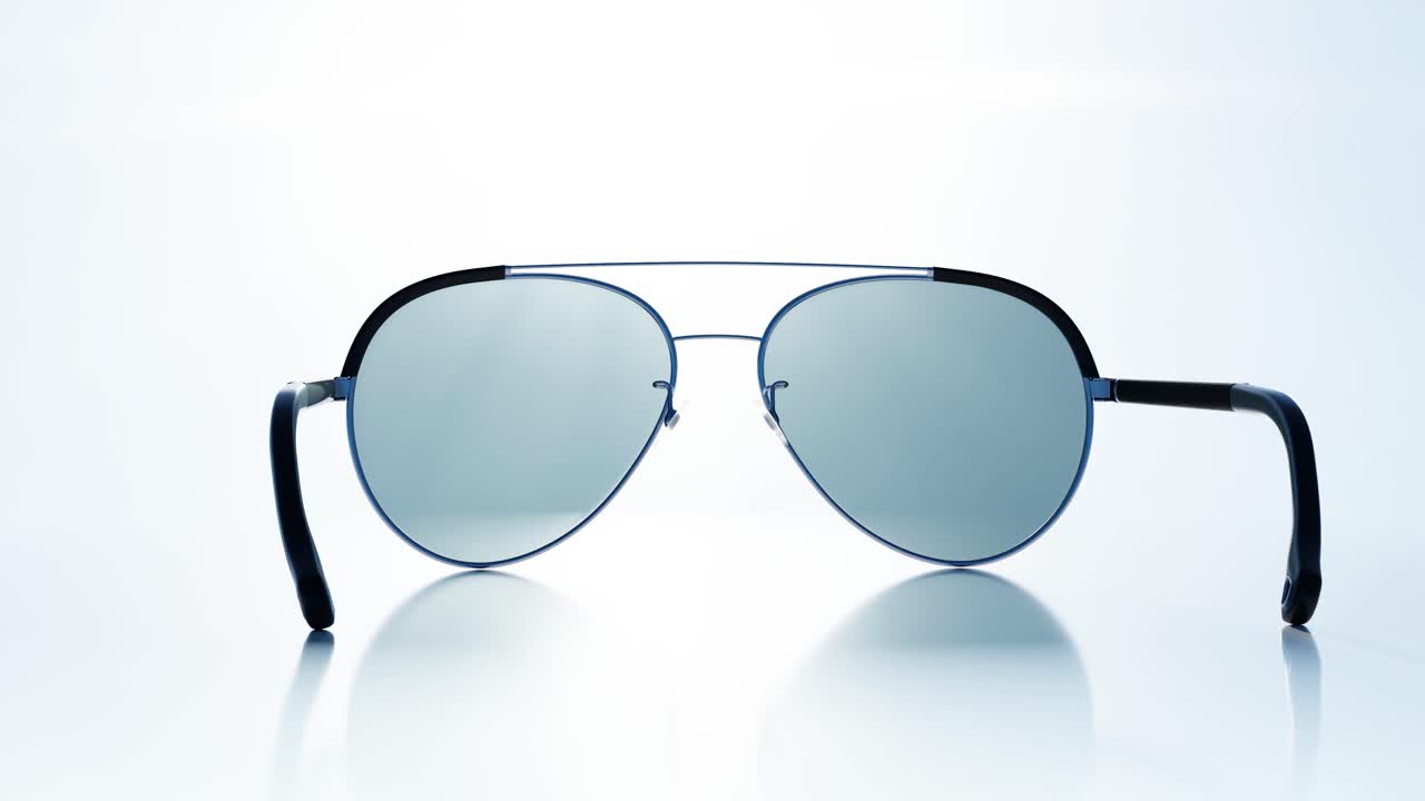 Stylish Aviator Sunglasses Rotating on a Reflective Surface