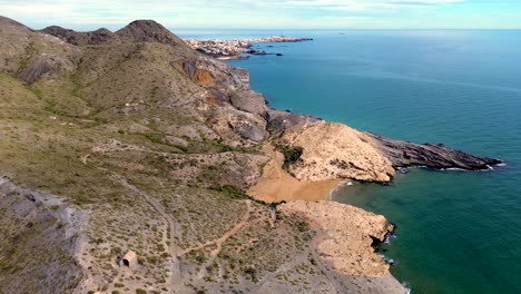 calblanque coast aerial drone view point of coastline of mountains against mediterranean seascape in cartagena coasts, spain