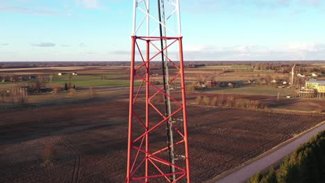 telecommunication antenna tower in agriculture field in close up drone view