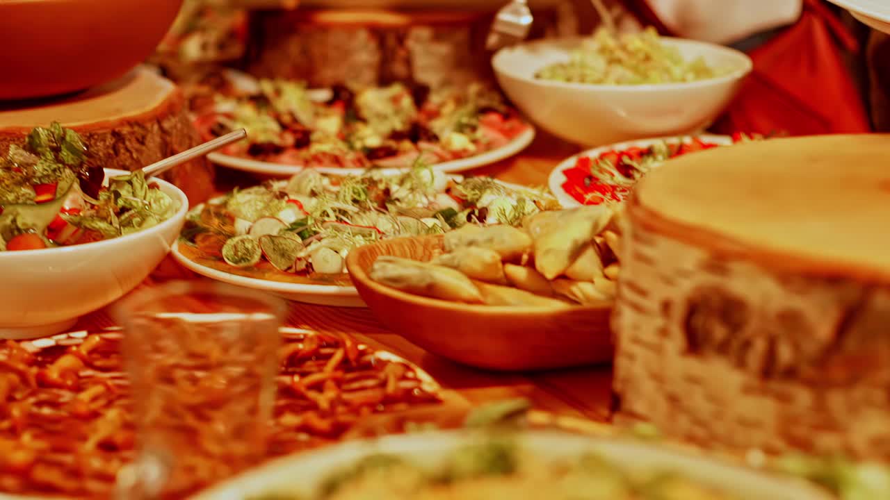 Plates of Mediterranean seafood dishes served in bowls with herbs and garnish on wood table