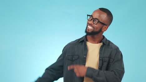 pointing, smile and face of black man in studio