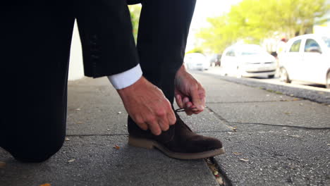 businessman tying up his shoelaces